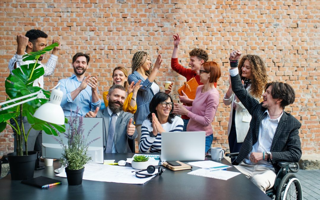 Entrepreneurs working on project indoors in office, celebrating successful contract.