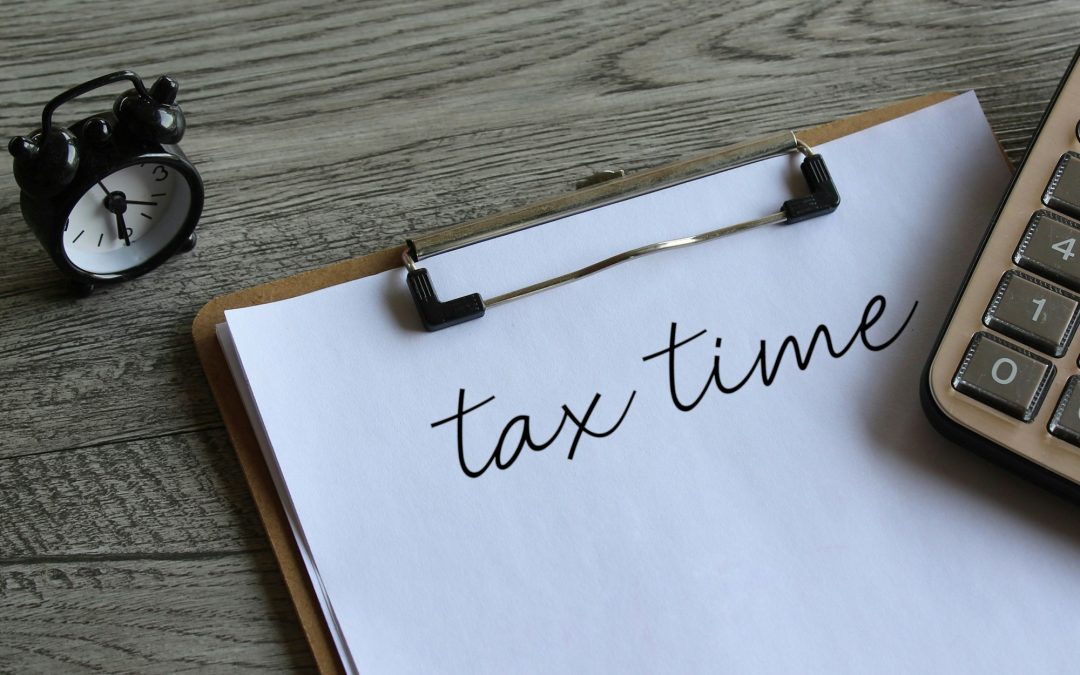Alarm clock and calculator with text TAX TIME.