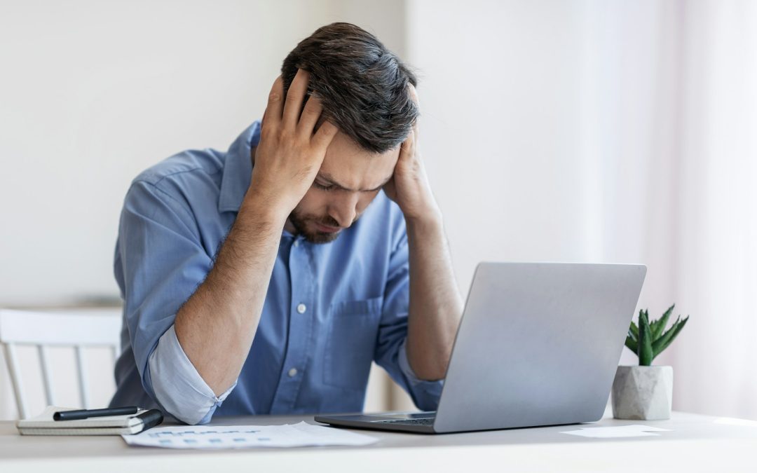 Bankruptcy Concept. Depressed male entrepreneur suffering from business failure, sitting at