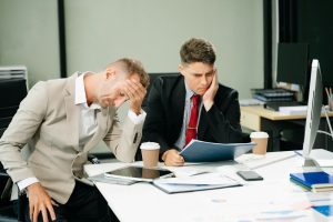 Furious two businesspeople arguing strongly after making a mistake at work